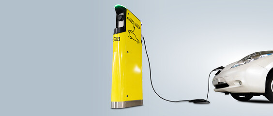 Charging electric car isolated on grey background. Copy space