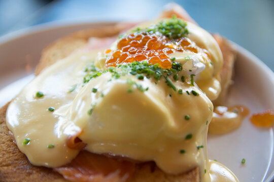 Eggs Benedict Royal, with smoked Salmon, poached eggs, Hollandaise sauce, Caviar and scallion, over a fresh brioche bread. 