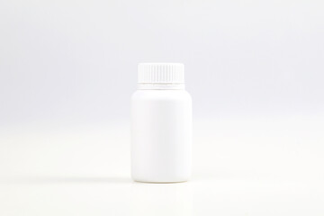 White plastic medicine bottle on white background