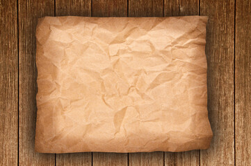 old crumpled paper on wood background