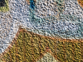 Hooligan smeared paint the walls of the old building. Landscape style. Grungy concrete surface with cracks, scratches and streaks of paint. Great background or texture.