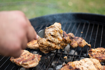Juicy meat with grilled vegetables (Steak, pork, beef, pepper, salt, grill). The cook pours beer on the juicy meat
