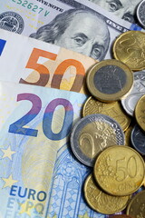 The currency of European countries, the US currency. Cash paper money and metal cents. Cash is stacked on top of each other and strewn with cents. Exchange of dollars into euros, exchange of euros int