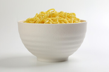 Fresh yellow egg noodle in bowl on whit background