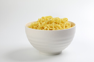 Fresh yellow egg noodle in bowl on whit background