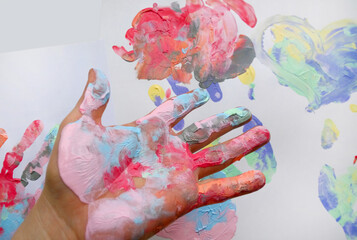 the imprint of a human hand with colorful paint and paint on the hand