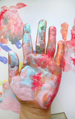 the imprint of a human hand with colorful paint and paint on the hand