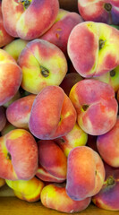 Saturn peaches on display at market.