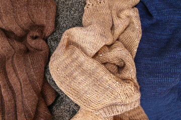 Fototapeta na wymiar Pile of colorful warm clothes on wooden background. Top view. Flat lay.