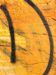 Landscape style. Grungy concrete surface with cracks, scratches traces of yellow paint on the...