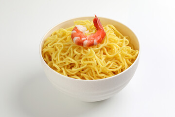 Fresh yellow egg noodle in bowl with prawn on whit background