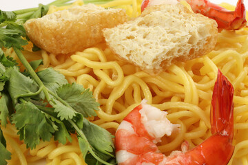 Fresh yellow egg noodle prawn tofu coriander leaf on whit background