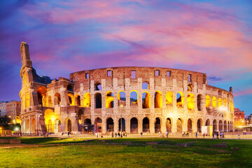 Naklejka na ściany i meble The Colosseum in Rome, Italy at colorful sunset twilight. The world famous colosseum landmark in Rome.