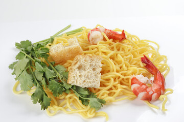 Fresh yellow egg noodle prawn tofu coriander leaf on whit background
