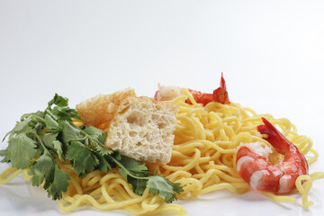 Fresh yellow egg noodle prawn tofu coriander leaf on whit background