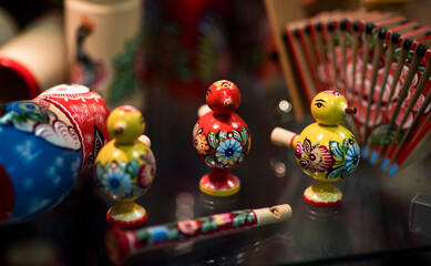 Beautiful vintage colourful wooden dymkovo dolls at market. Dymkovo dolls is folks cultural symbol of Russia. With selective focus on one doll