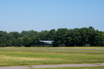 Fototapeta na wymiar Personal airplane in the field taking off