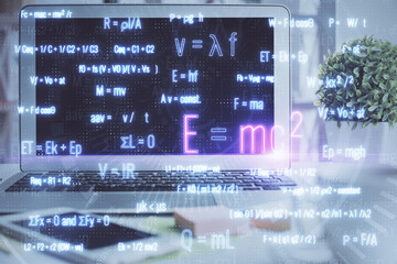 Desktop computer background and formula hologram writing. Double exposure. Education concept.