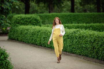 Beautiful pregnant girl walking in the Park.