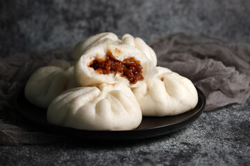 Steamed BBQ pork bun, also know as Baozo, is a type of filled bun or bread-like dumpling in various...