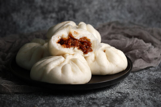 Steamed BBQ pork bun, also know as Baozo, is a type of filled bun or bread-like dumpling in various Chinese cuisines.