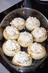 Stuffed mushrooms stuffed with cheese, mushroom stalks and onions. In a baking dish.