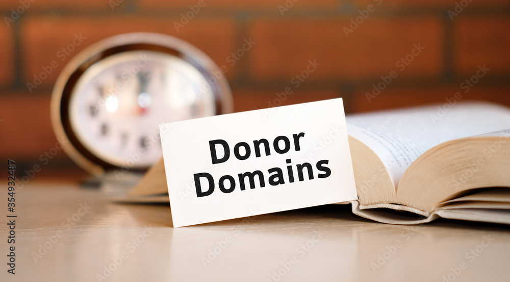 Poster donor domains concept text on a white background with a clock and an open book