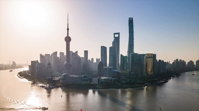 Sunny Day Time-lapse or Hyper-lapse Aerial View of Oriental Pearl Tower Financial District Pudong. Shanghai Tower on the Bund Huangpu River. Ships Sail Around Downtown City Center above Waitan Puxi.