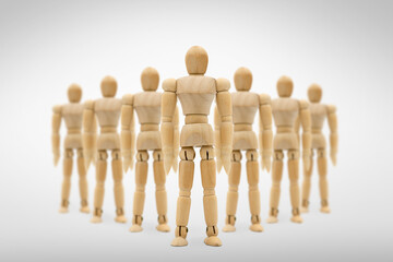 Wooden figure businessman standing out from the group.Leadership and growth in business concept.