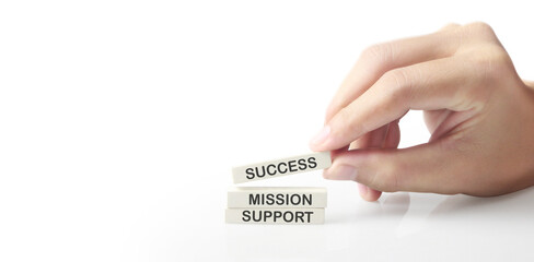 Cube with words success, company, support, quali ty, mission, business, in hand