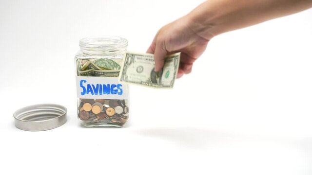 439 Putting money into a money-saving jar