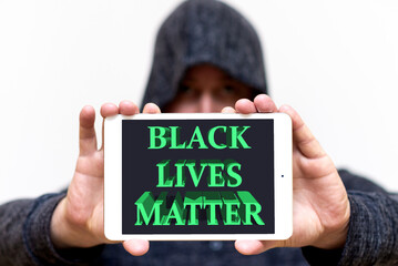 Portrait of a hooded white man holds tablet with the inscription Black Lives Matter. protests of...