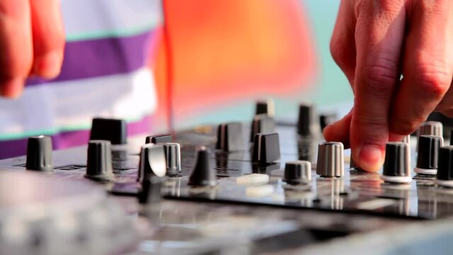 DJ playing music at mixer close up. Dj at the beach party