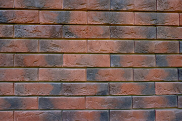 A wall of ceramic brick. Stone structure, facade.