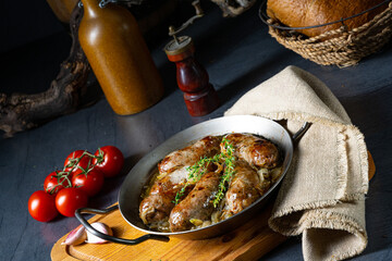 Homemade white sausage fried with onion and herbs