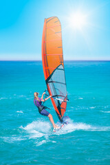 Beautiful cloudy sky with Windsurfer Surfing The Wind On Waves In Alacati - Cesme, Turkey 