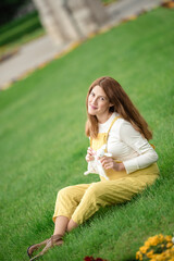Fototapeta premium Expecting young female mother posing in park holding plush toy