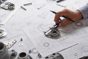 Engineer technician designing drawings mechanical parts engineering Engine.manufacturing factory...