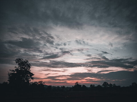 Beautiful sunset with village beauty on the background of clouds.