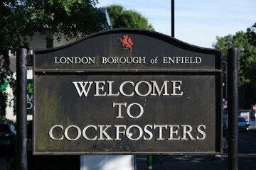 London Borough of Enfield boundary sign. Texts read: Welcome to Cockfosters.
