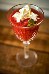 cocktail with fresh strawberries on an old rustic table