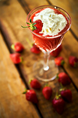 cocktail with fresh strawberries on an old rustic table