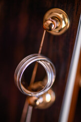 Wedding rings close up on a guitar, selective focus