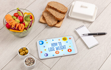 Healthy Tablet Pc compostion with HOW TO LOSE WEIGHT inscription, weight loss concept