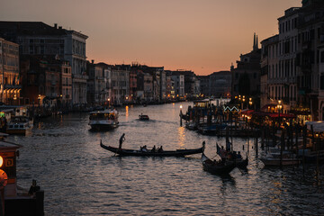 Gondoliers at dusk on the Grand Canal of Venice, Italy.