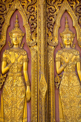 Thai golden angel sculptures stucco on the temple walls