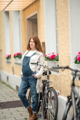 Fototapeta na wymiar happy smiling pregnant woman with bag at city street