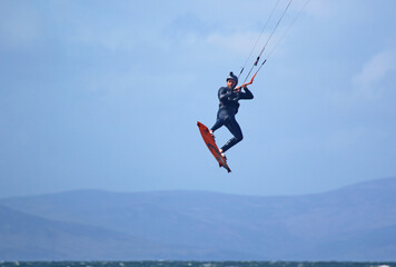 Fototapeta na wymiar kitesurfer jumping at Troon, Scotland 