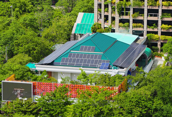 Solar panel on a roof azure in the urban green office garden environment.