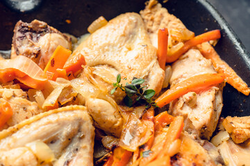 Roasted chicken on the pan with carrot, onion, gralic and other spices. Selective focus. Shallow depth of field.